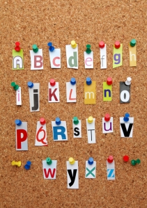 Letters of the alphabet cut out and pinned to a notice board