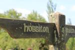 Wooden sign showing Hobbiton from the film set in Matamata, New Zealand